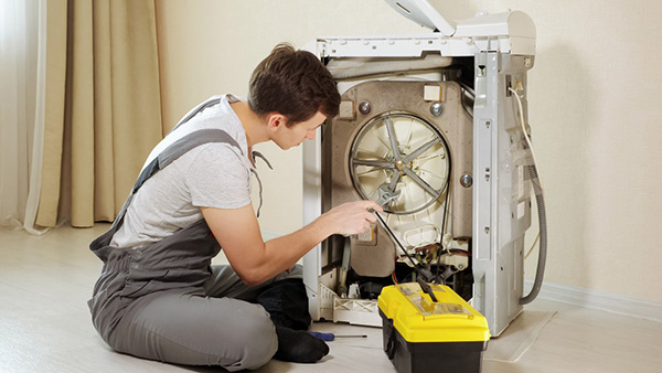 washing machine being repaired